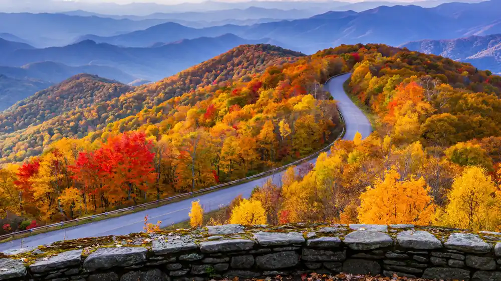 Blue Ridge Parkway winding through Appalachian ridges in peak fall foliage