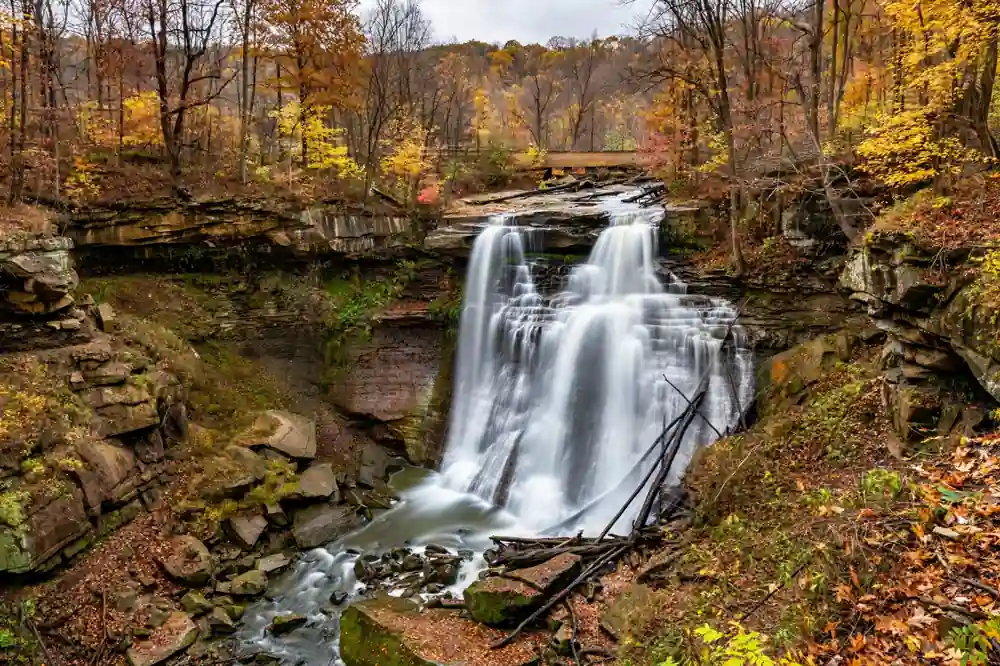 Brandywine Falls cascading over sandstone cliffs in Cuyahoga Valley National Park in autumn