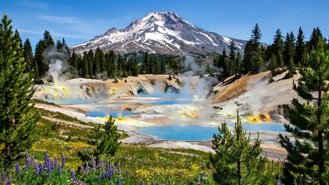 Lassen Peak above steaming hydrothermal pools in Lassen Volcanic National Park